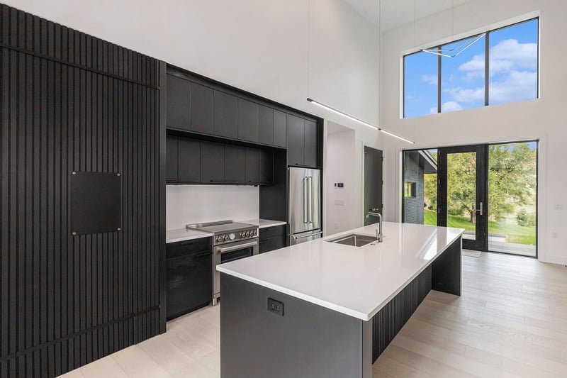 West Michigan great room with modern fireplace, expansive windows, and natural ligh