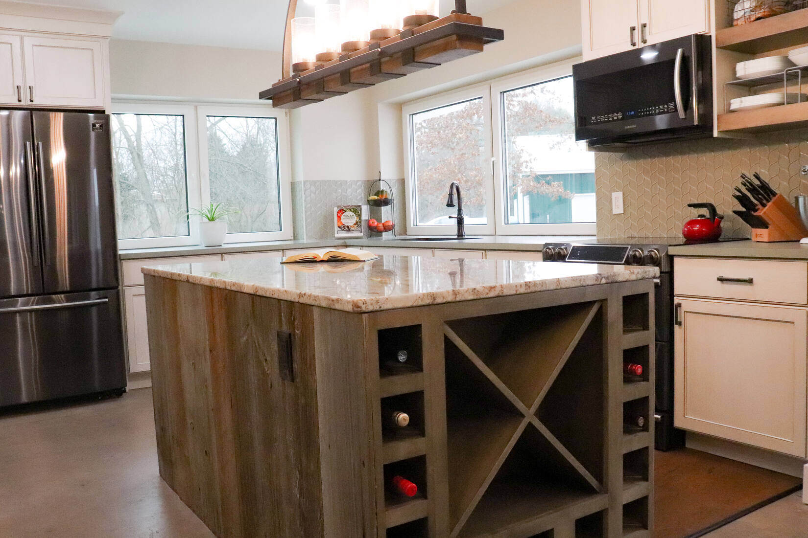 Rustic kitchen with a wooden island and modern appliances in a custom home by R Value Homes in West Michigan
