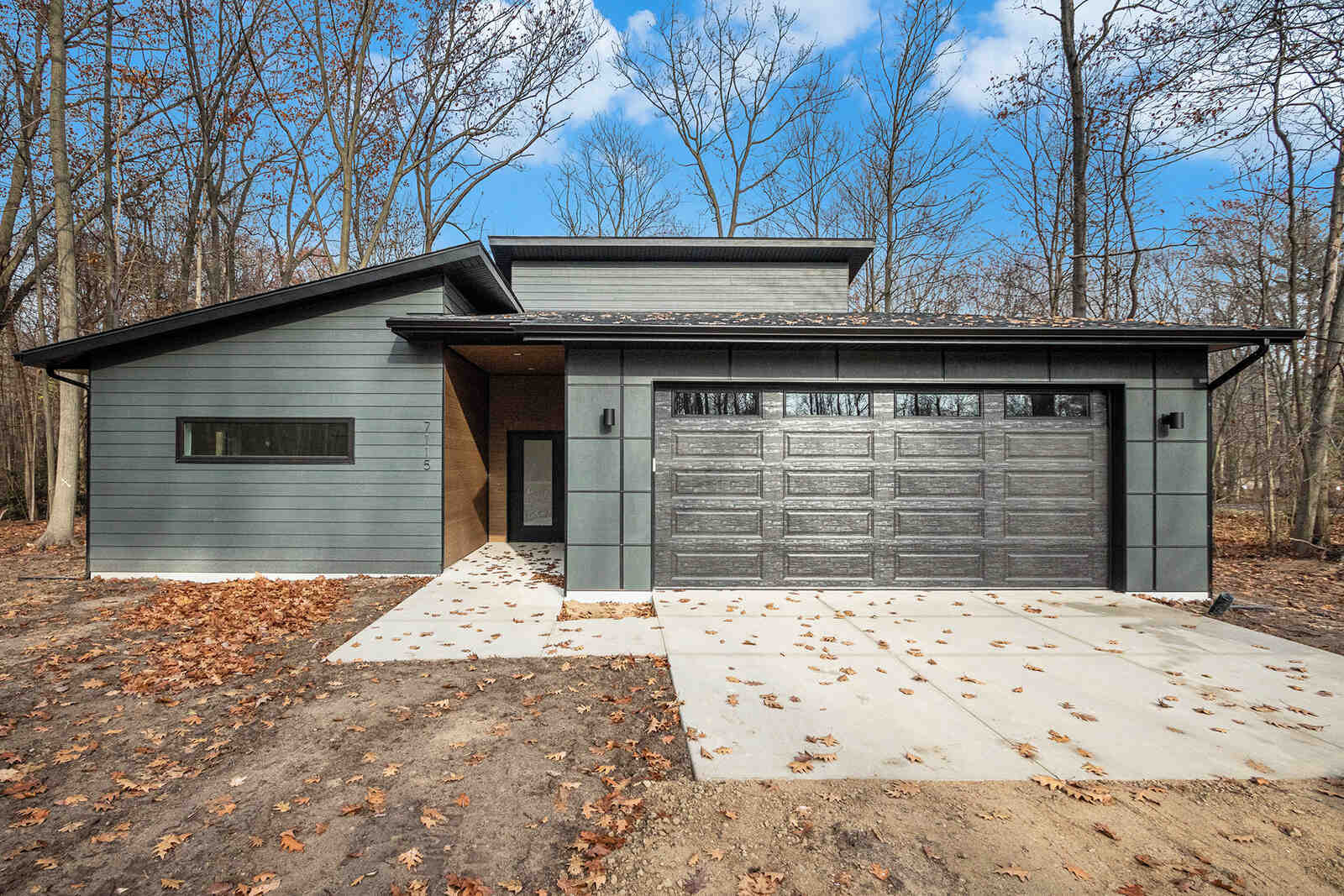 Contemporary home with a gray exterior and large garage, built by R Value Homes in West Michigan