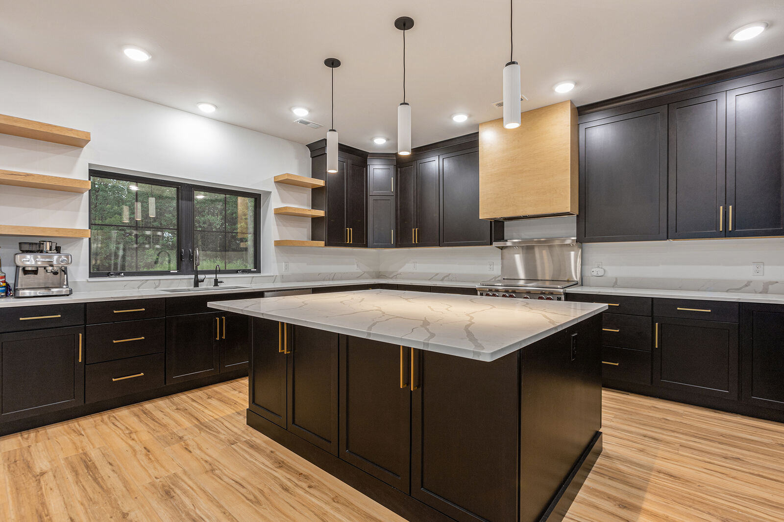 Contemporary kitchen with dark cabinetry and marble countertops by R-Value Homes in West Michigan Contemporary kitchen with dark cabinetry and marble countertops by R-Value Homes in West Michigan