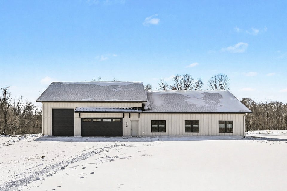 Full exterior view of a custom-built ranch-style home in Grand Rapids West Michigan with a modern black roof and cream siding