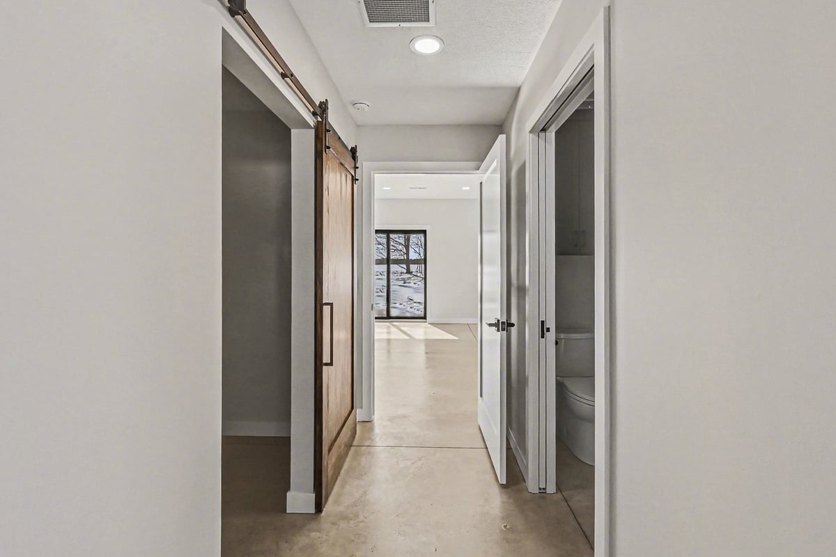 Hallway featuring custom barn door in a custom home in West Michigan