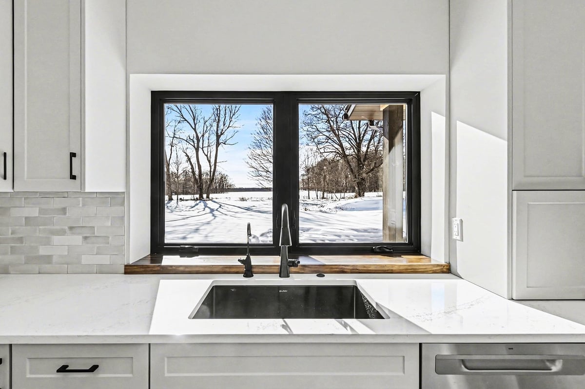 Kitchen sink view from a custom West Michigan home, overlooking backyard