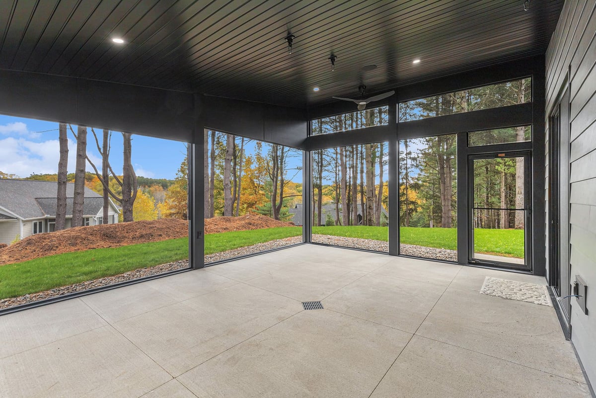 Outdoor patio and porch of a custom home by R-Value Homes in West Michigan, with ceiling fan